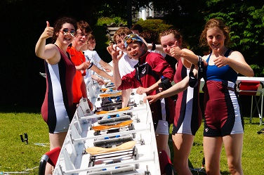 J15 Rowers, at a competition, preparing a crew boat for a race